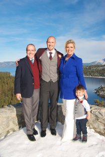 A family posing for a picture on top of a mountain.