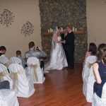 A couple getting married in front of the wedding party.