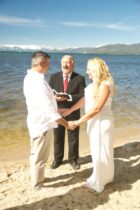 A couple getting married by the water