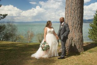 A bride and groom standing next to each other.