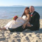 A man and woman sitting on the beach