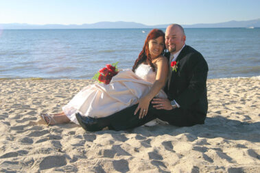 A man and woman sitting on the beach