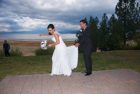 A bride and groom pose for the camera.