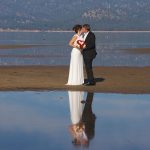 A man and woman kissing on the beach