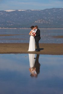A man and woman kissing on the beach