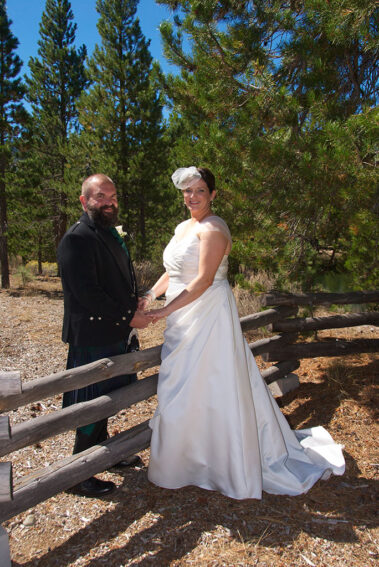 A bride and groom posing for a picture.
