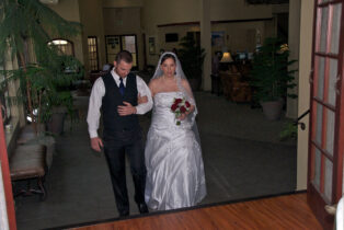 A man and woman walking down the aisle.
