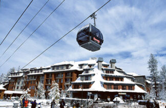 A ski lift with people on it and snow covered trees.