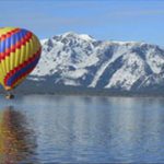 A hot air balloon floating on top of water.