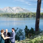 A couple getting married by the water