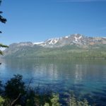 A lake with mountains in the background and trees