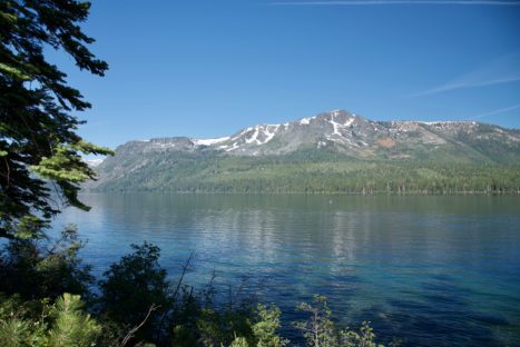 A lake with mountains in the background and trees