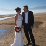 A man and woman standing on the beach