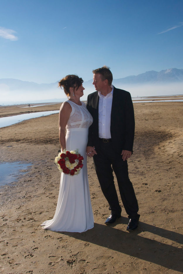 A man and woman standing on the beach