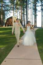 A man and woman walking down the aisle.
