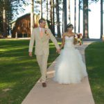 A man and woman walking down the aisle.